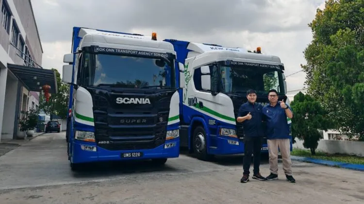 Representative from Kok Onn Transport Agency with a representative of Scania Malaysia in the handover ceremony.