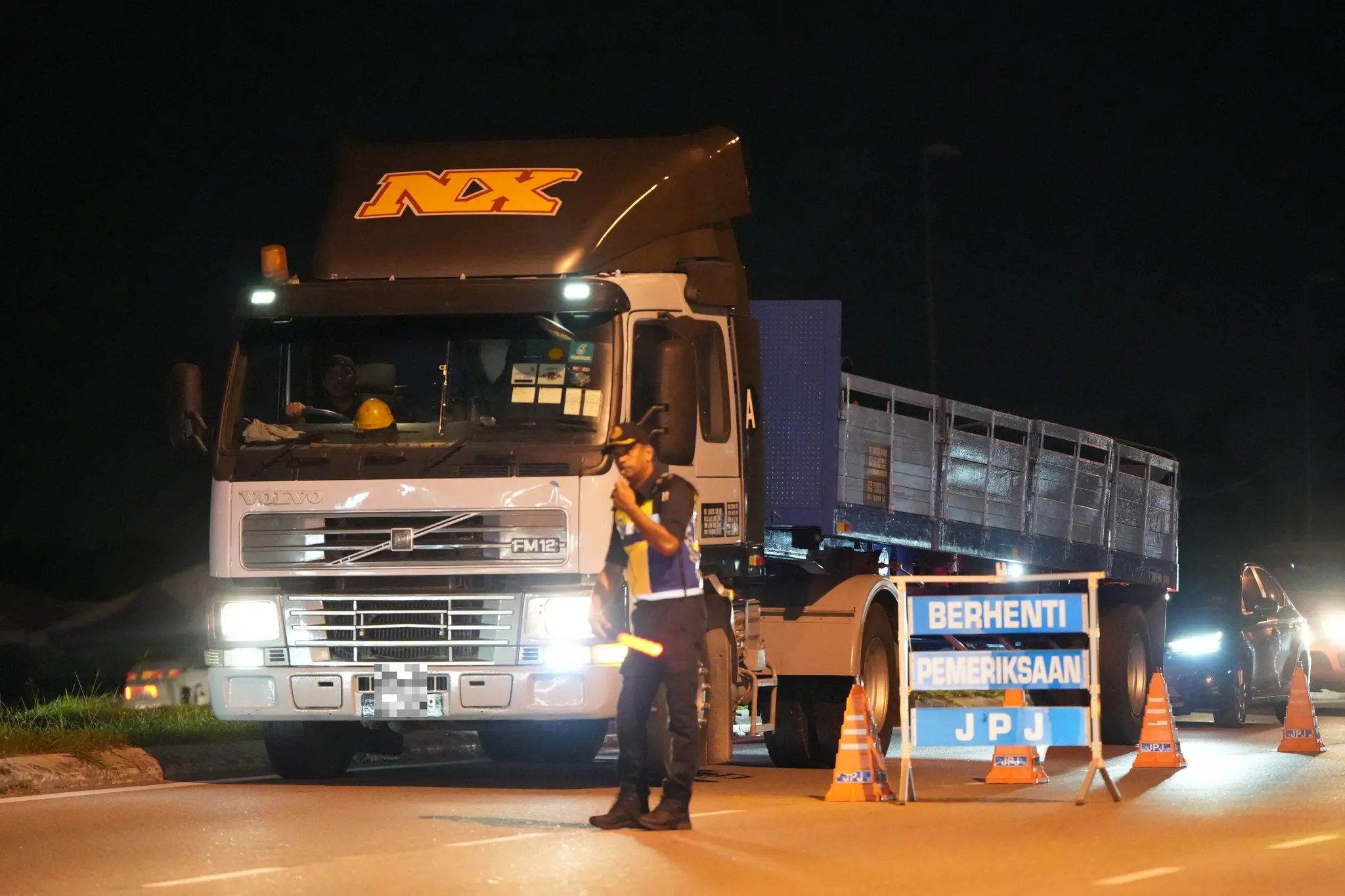 A JPJ officer conducting an operation.