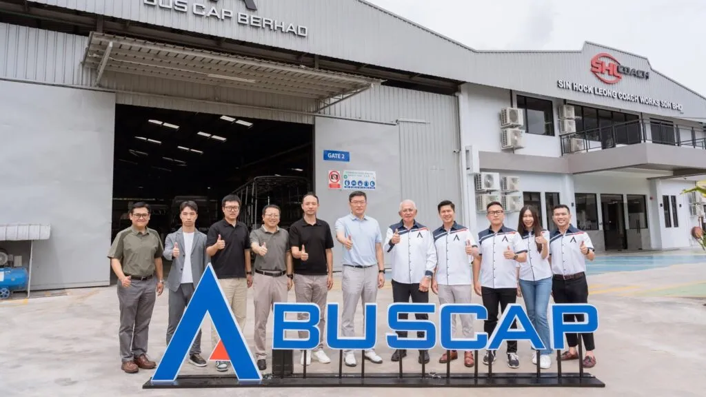 Representatives from Bus Cap Berhad and BYD standing outside the Bus Cap Berhad manufacturing facility in Ipoh, Perak. (Photo: Bus Cap Berhad/Facebook)
