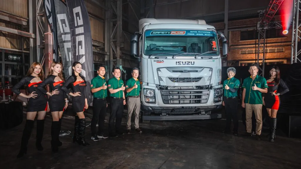 Isuzu Malaysia executives and brand ambassadors posing alongside a white Isuzu GIGA Euro 5 heavy-duty truck during the launch event. (Photo: Isuzu Malaysia)